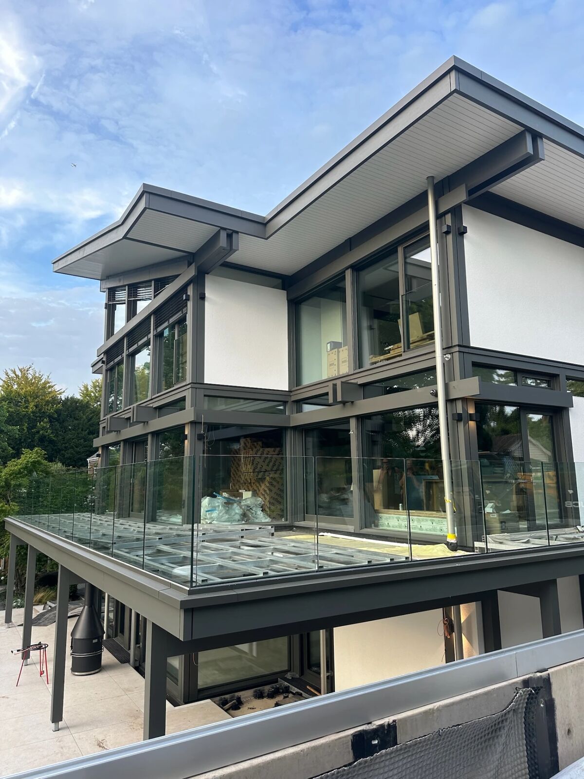 The glass and timber exterior of the client's Huf Haus home in Ascot