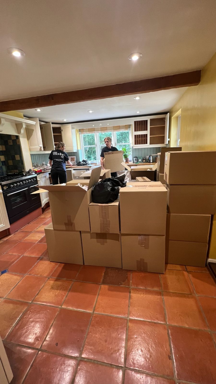 Two Your Moving Day organisers unpacking boxes in the Oxfordshire cottage kitchen